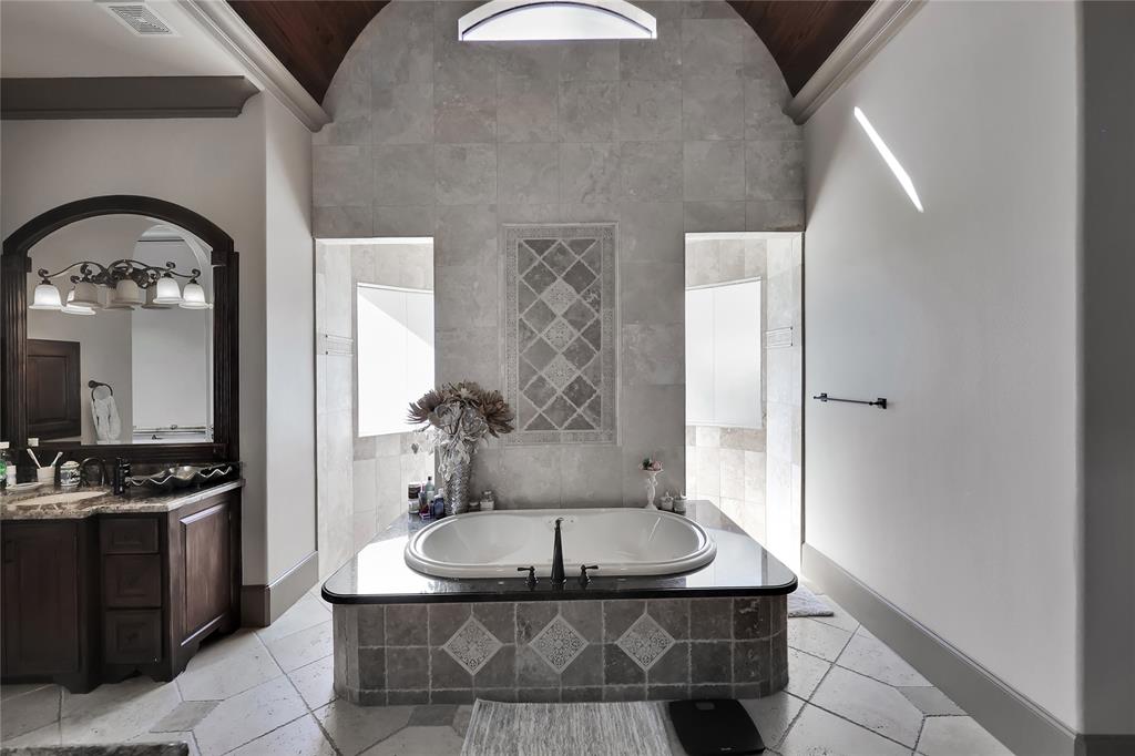 Primary Bathroom Oasis with walk-in shower, large jetted tub, and his and her sinks and vanity to get ready in the mornings!