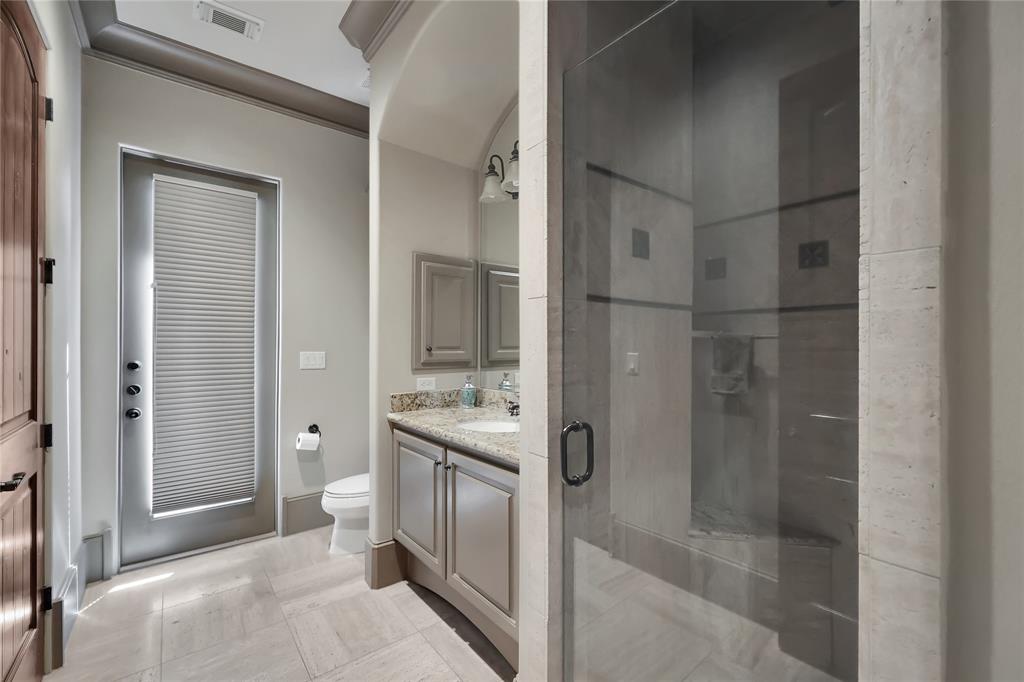 !Full Bathroom downstairs with terrific tile flooring, granite countertops, glass encases shower, and outside access for pool time accommodations!