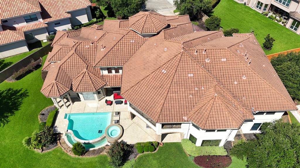 This Amazing Aerial View showcases the abundance of space offered on a HUGE lot with a Sparkling Pool, Covered Patio & more.