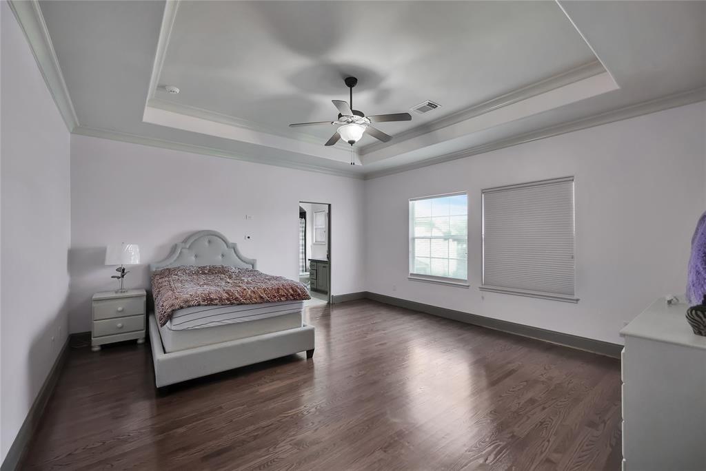 Spacious Secondary Bedroom 5 on the second level with wood flooring, Trey ceilings, and an abundance of space.