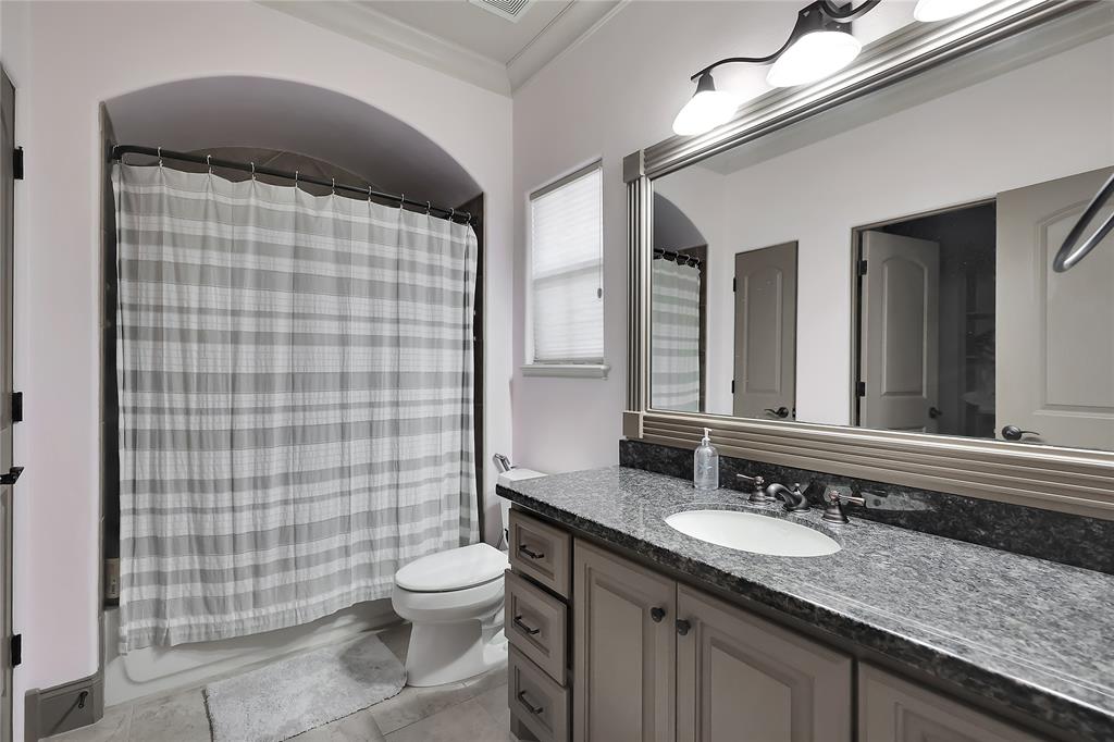 Private Bathroom with tile flooring, granite tops, extended mirror, and tub/shower with tile surround!