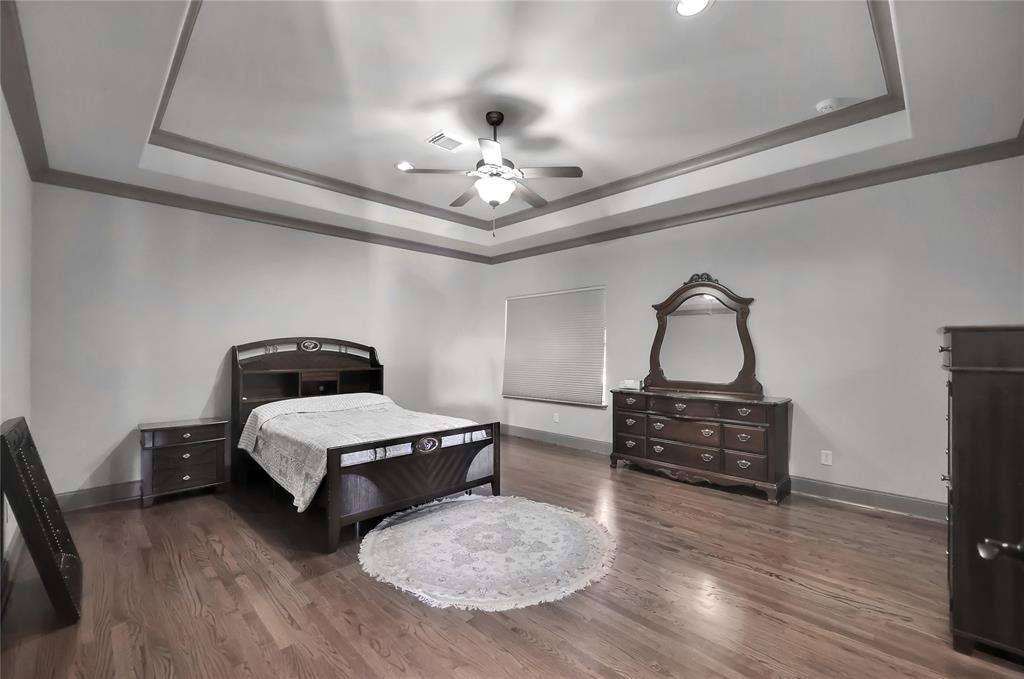 Spacious Secondary Bedroom 6 on the second level with wood flooring, Trey ceilings, and an abundance of space.