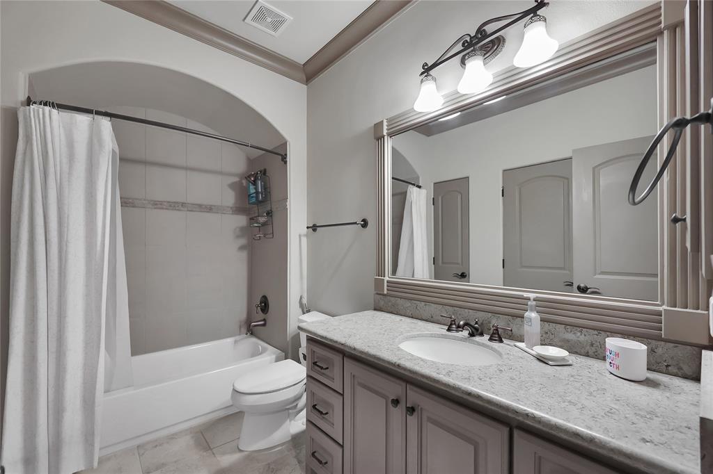 Private Bathroom with tile flooring, granite tops, extended mirror, and tub/shower with tile surround!