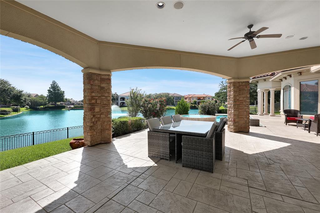 Covered Patio out back with tons of space, tile flooring, ceiling fan and Lake View!