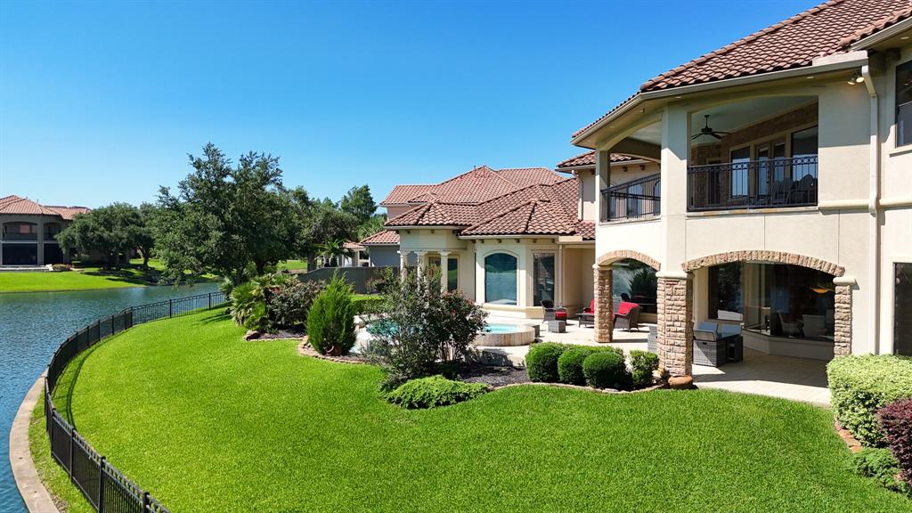 Another view of the Backyard Oasis with lush landscaping, a Covered Patio and Balcony, and space to entertain and enjoy all year round.