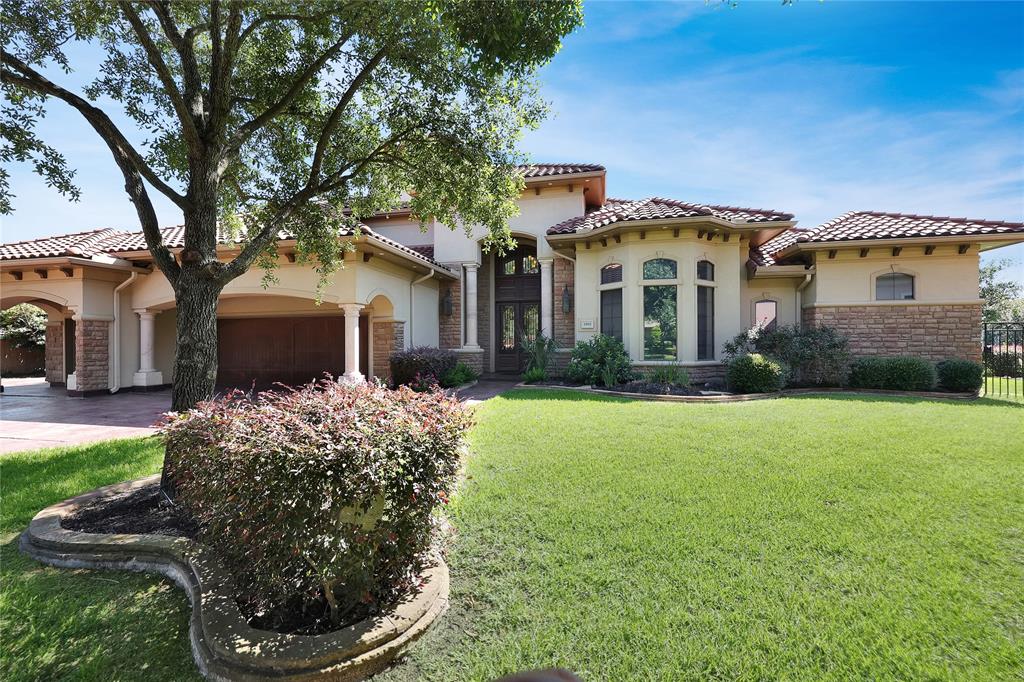 Alternate view of the lush landscaping offered at this gorgeous home as well as the mature trees for more shade!