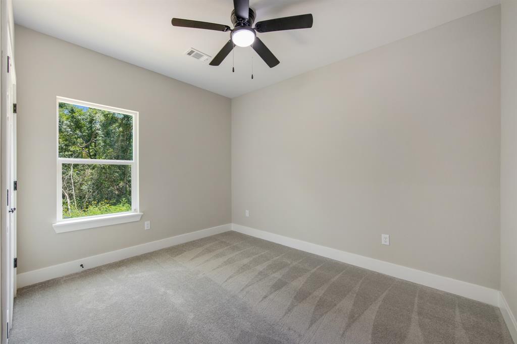 Secondary bath with over the toilet cabinets, behind the door shelving, and tub/shower combo