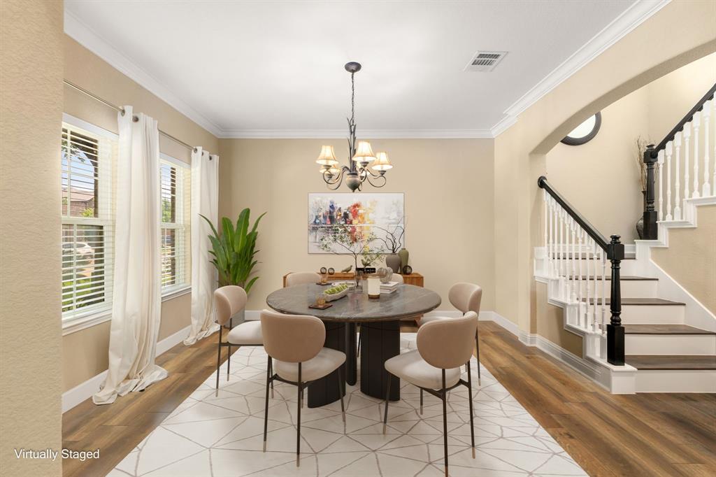 Make memories gathered around the table with your family and friends! This dining room features crown molding, large windows, wood floors and a beautiful chandelier.