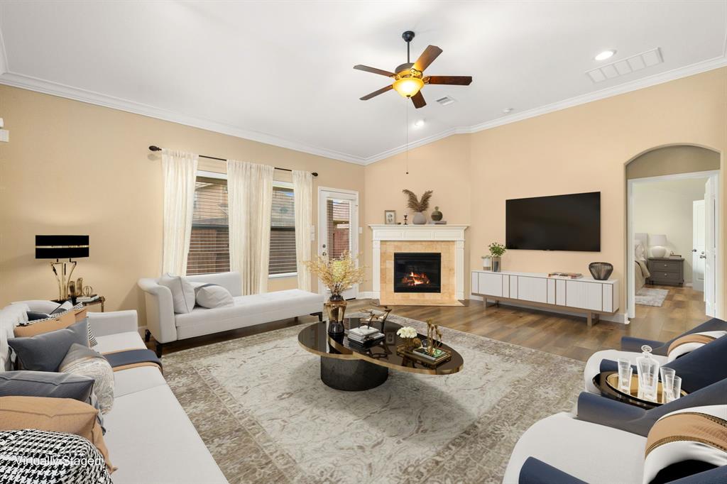 This additional view of the living room showcases the gorgeous fireplace, custom paint, large windows with blinds allowing natural light in and great access to your backyard.