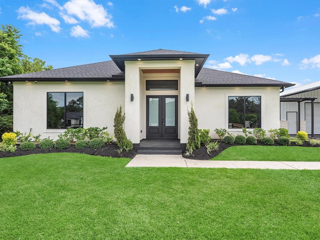 4 sides stucco with a black shingled roof, and a lovely entry point!