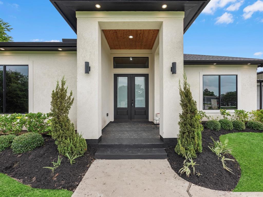 4 sides stucco with a black shingled roof, and a lovely entry point!