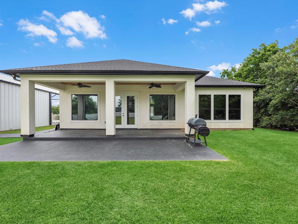 Back patio featuring cedar ceiling, ceiling fan, and a extended slab for entertaining.