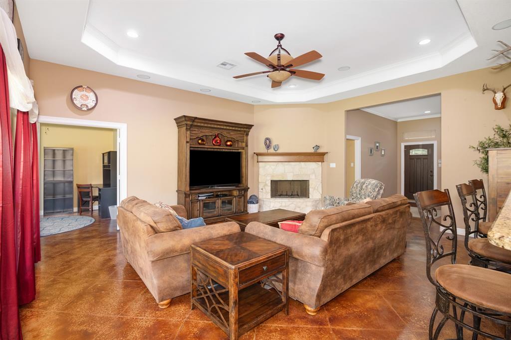 Spacious living room with room for any sitting arrangement that you desire and a prominent wooden fireplace surround.