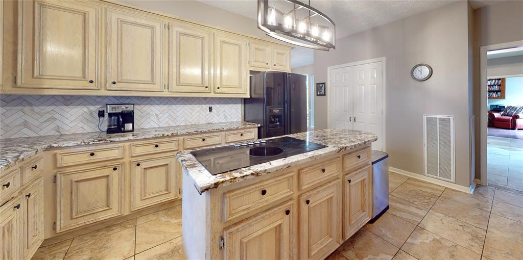 Beautiful cabinetry, absolutely gorgeous granite countertops with a pass-through to both living and dining rooms.