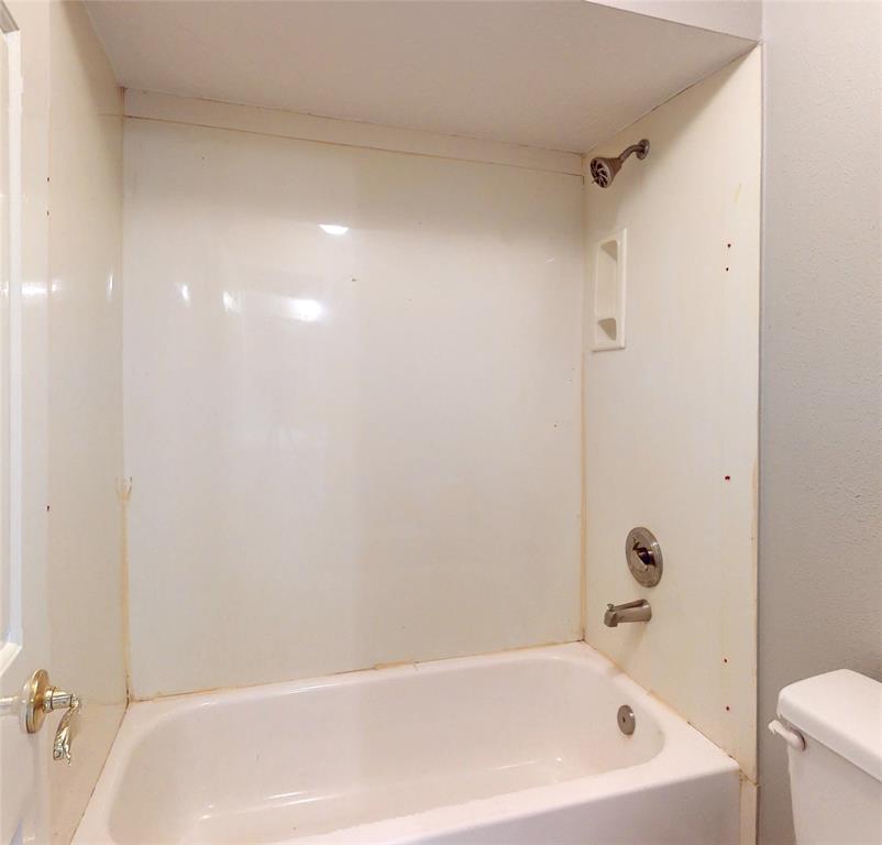 Looking back into bedroom #3, the vanity and large lighted mirror can be seen.