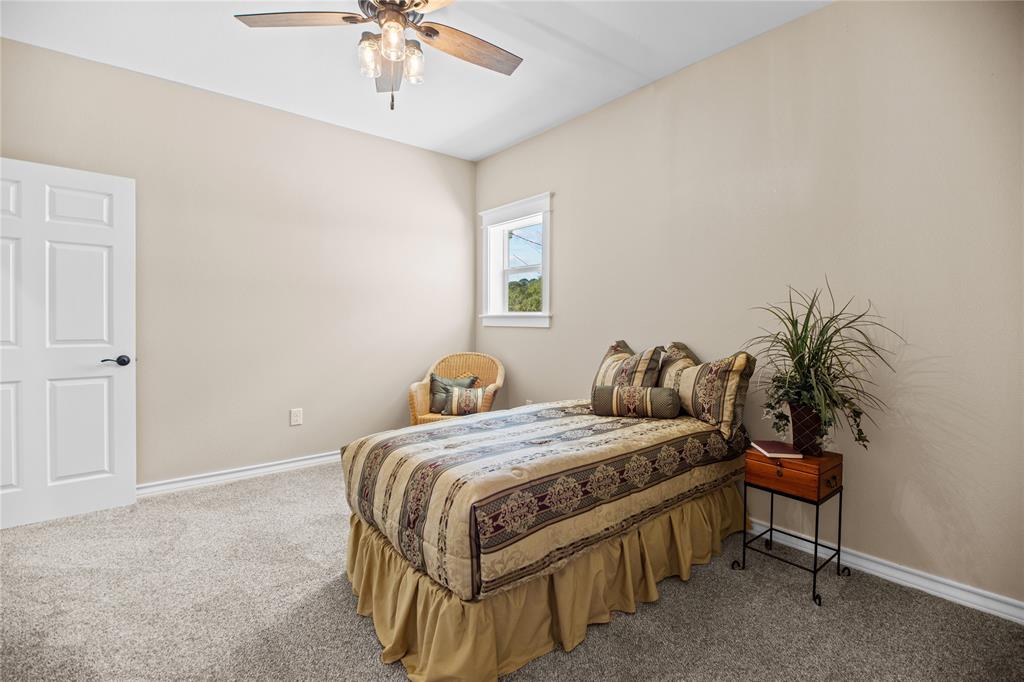 Bedroom #2 with carpet, walk-in closet, & ceiling fan