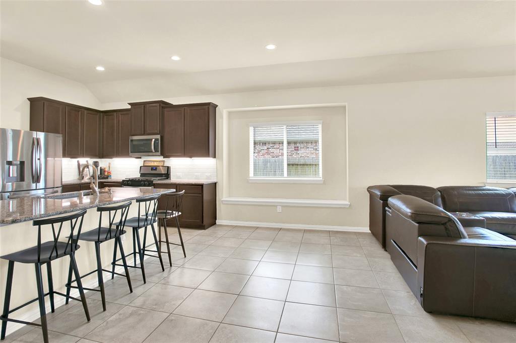 Large area for a breakfast table and chairs. Nice big windows bringing in lots of natural lighting with a seating area to sit under the window.