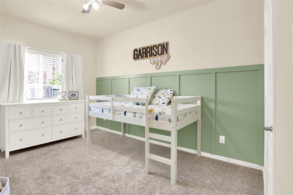 One of two secondary bedrooms with a beautiful painted wood accent wall.