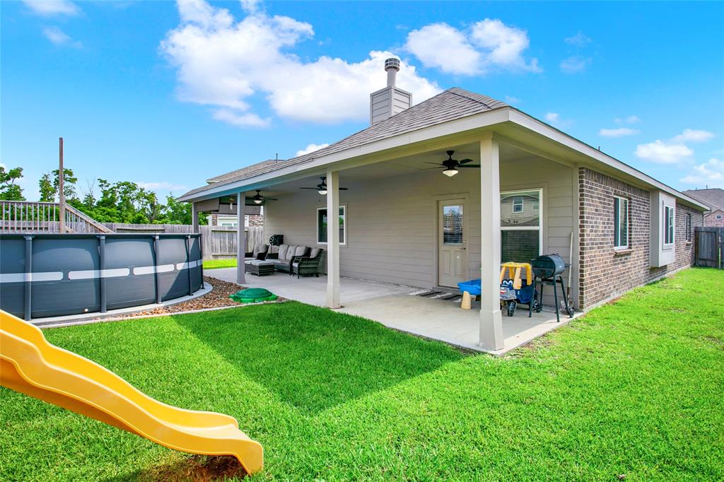 Nice size large showing the added extended cement and patio cover across entire home.