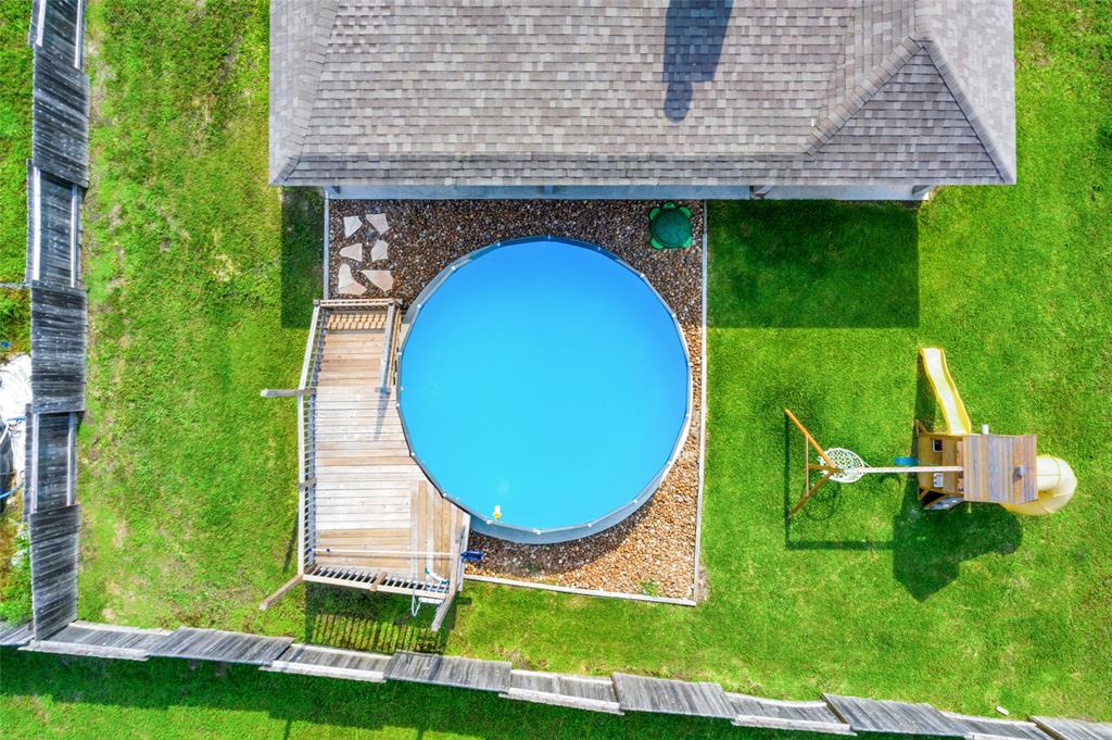 Aerial of back yard, pool and play area. Plenty of room on both sides of the home for toys, boats or trailers.