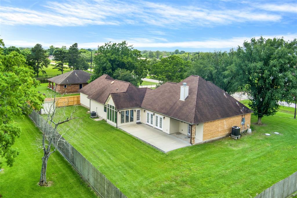 Back and side yard view of this near half acre. So spacious and spread out and plenty of room for YOUR perfect backyard! Pool, outdoor kitchen, garden, children’s play equipment, workshop, you name it!