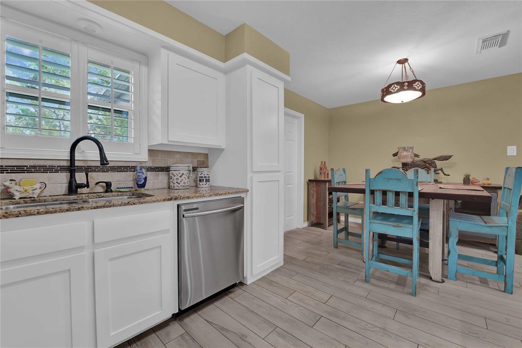 That window view is to the back yard and its gorgeous! Dish duty will not be that bad! Door on the right leads to the utility room which leads to the back patio.