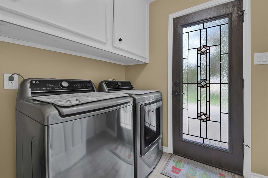 That\'s the nicest utility room door I\'ve ever seen! Plus there is a second full glass door to the exterior which goes to the back patio. Lots of storage in here!