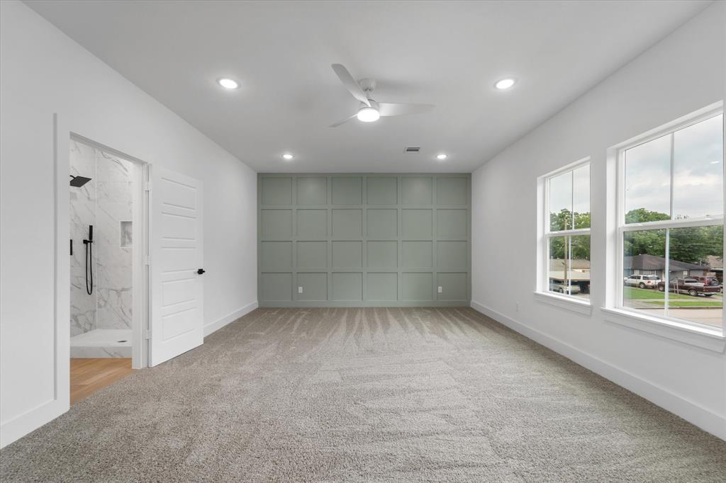 Dual vanities in the primary bathroom, with plenty of storage space and decorative lighting.