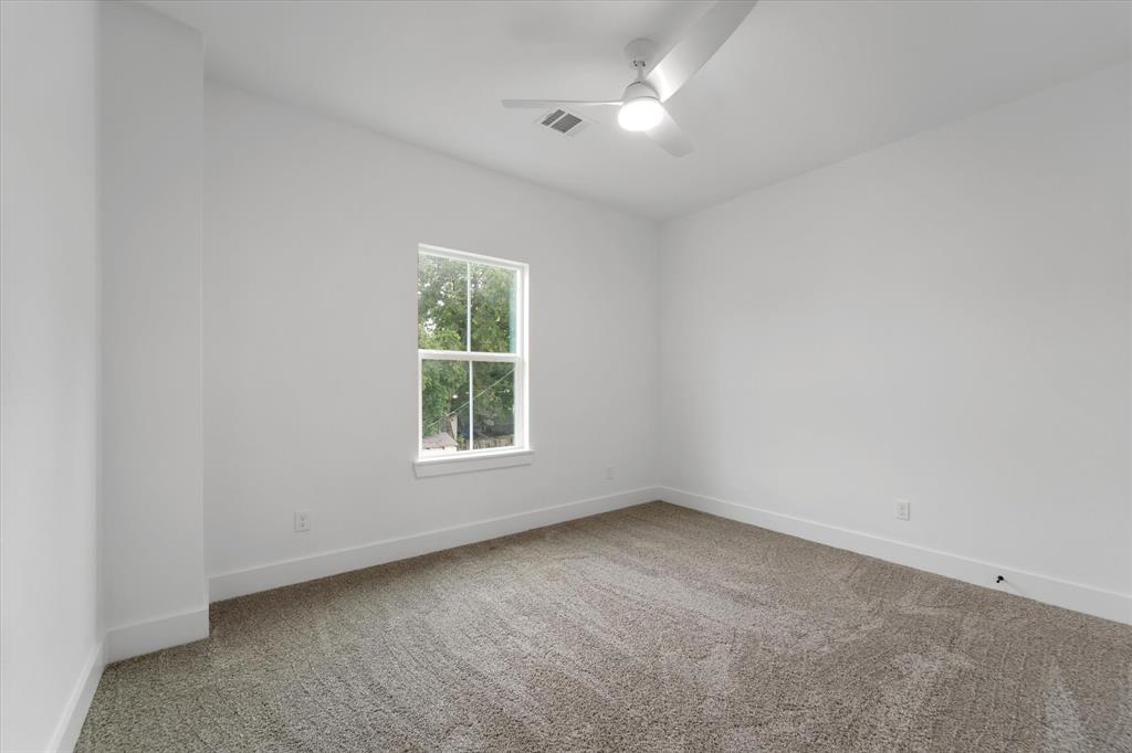 Bedrooms 3 upstairs, with a ceiling fan and plush carpet underfoot.