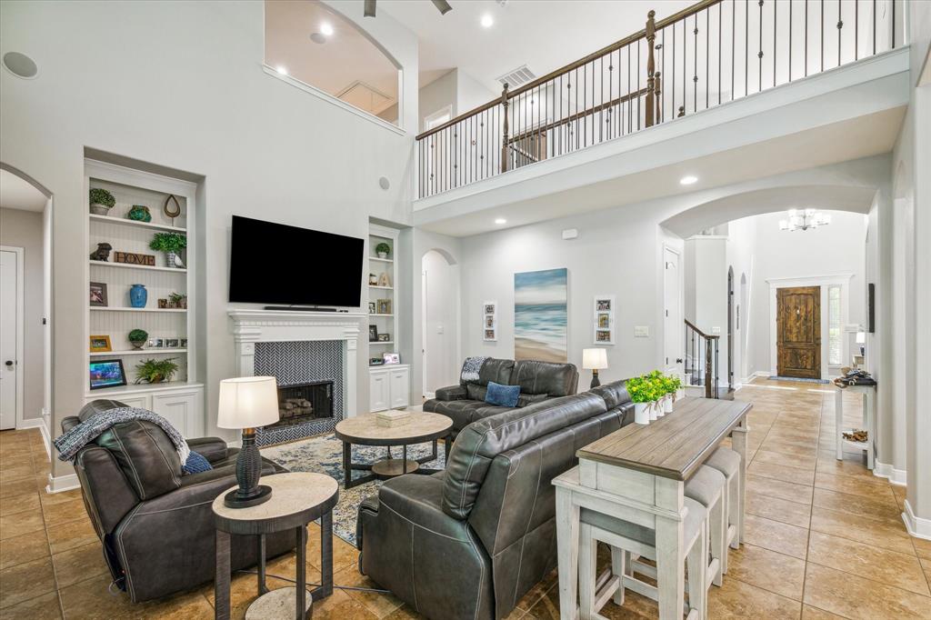 Living area with built ins and a gas fireplac