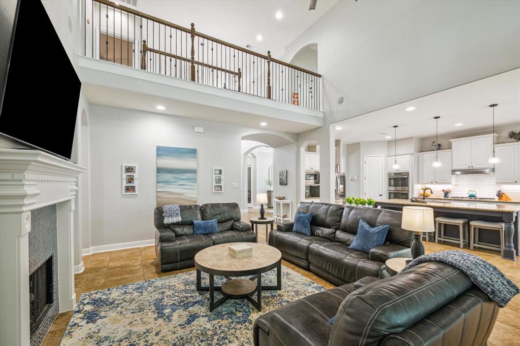 A spacious, open-concept living room opens to the kitchen and breakfast area.