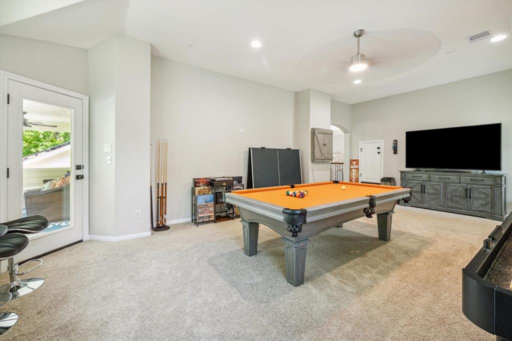 Game room with door leading to covered balcony