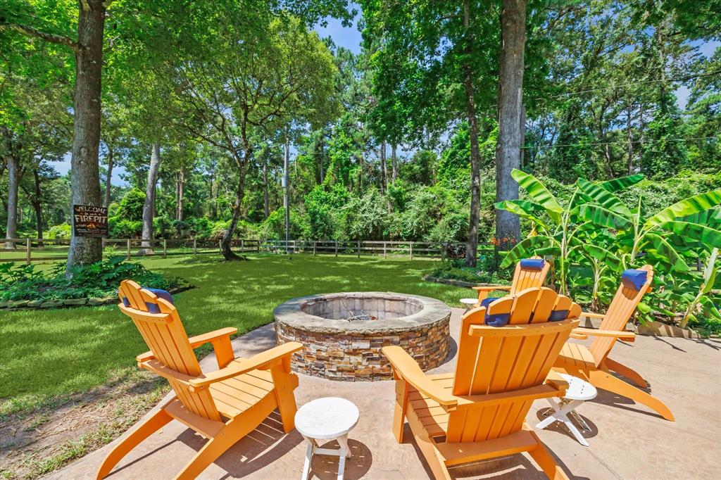 A fire pit surrounded by trees and lush greenery