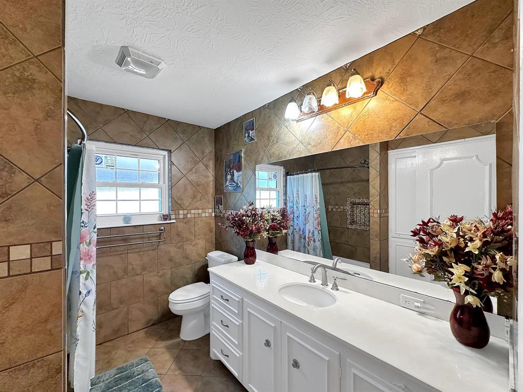 The large primary bathroom boasts luxurious amenities for a spa-like experience.