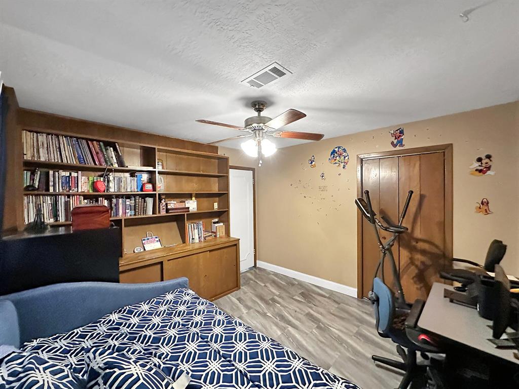 The spacious fourth bedroom is versatile, perfect for use as a bedroom or home office.