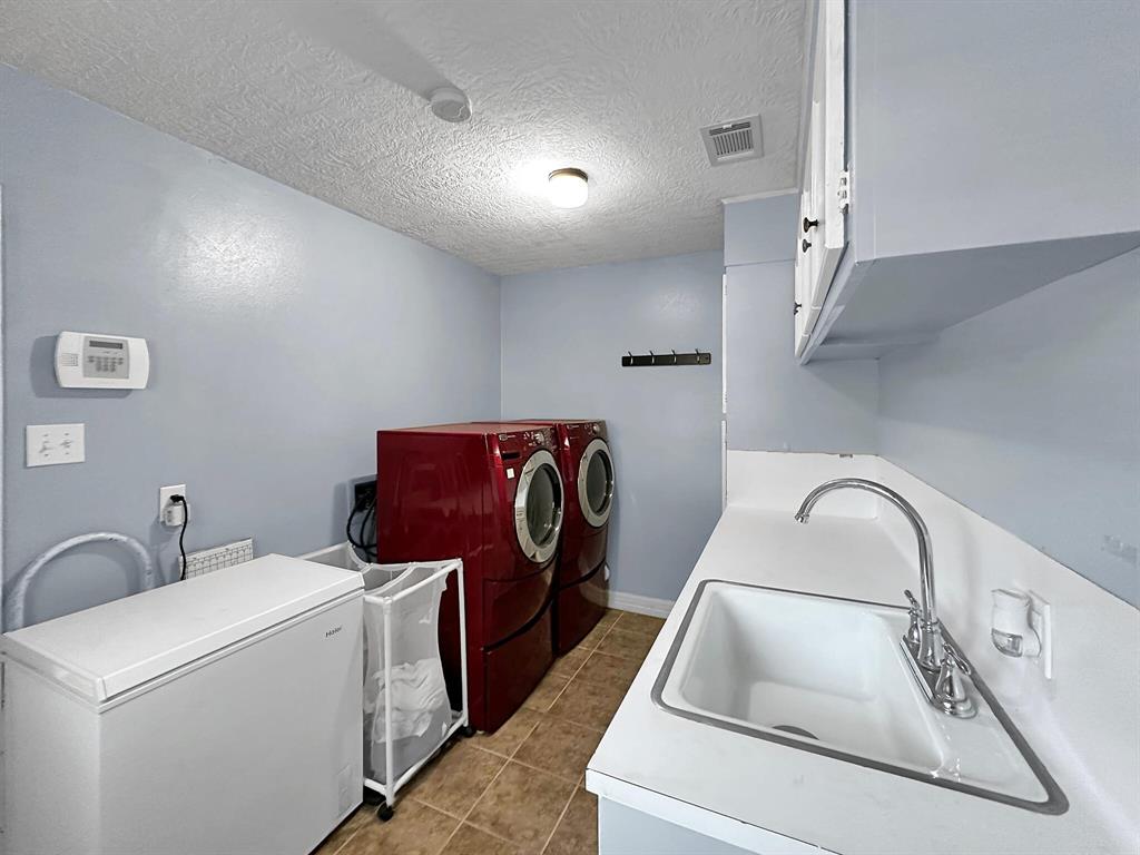 The house features a convenient in-house utility room for laundry and extra storage.