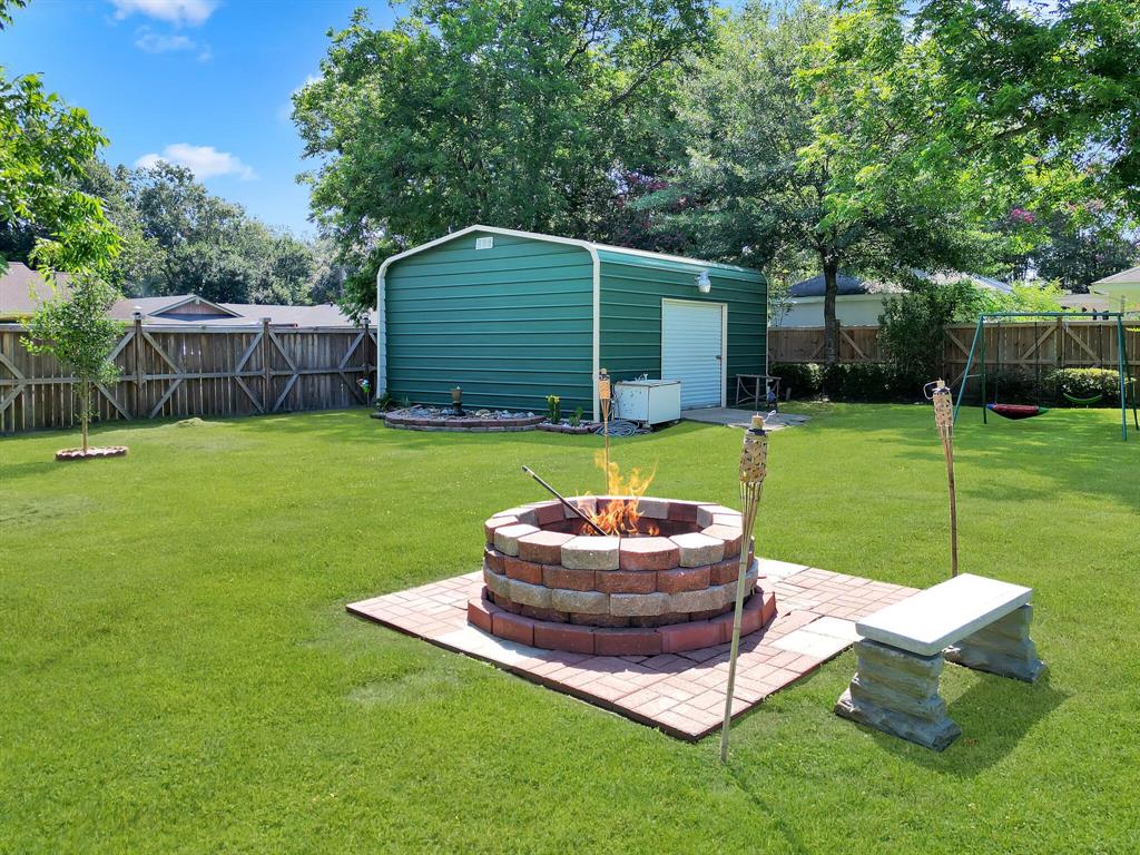 The gorgeous, huge yard features a beautiful fire pit, perfect for cozy evenings outdoors.