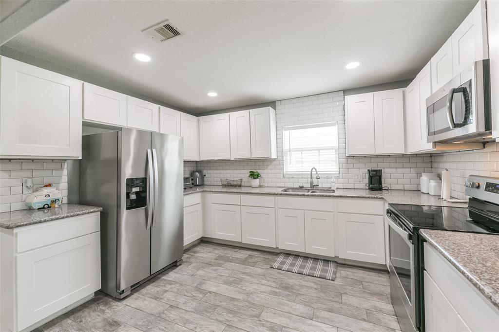 Kitchen features an abundance of cabinets offering ample storage, stainless steel appliances and granite countertops