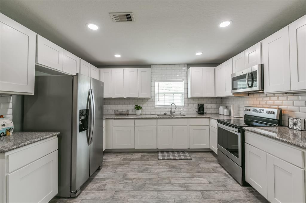 Kitchen features an abundance of cabinets offering ample storage, stainless steel appliances and granite countertops