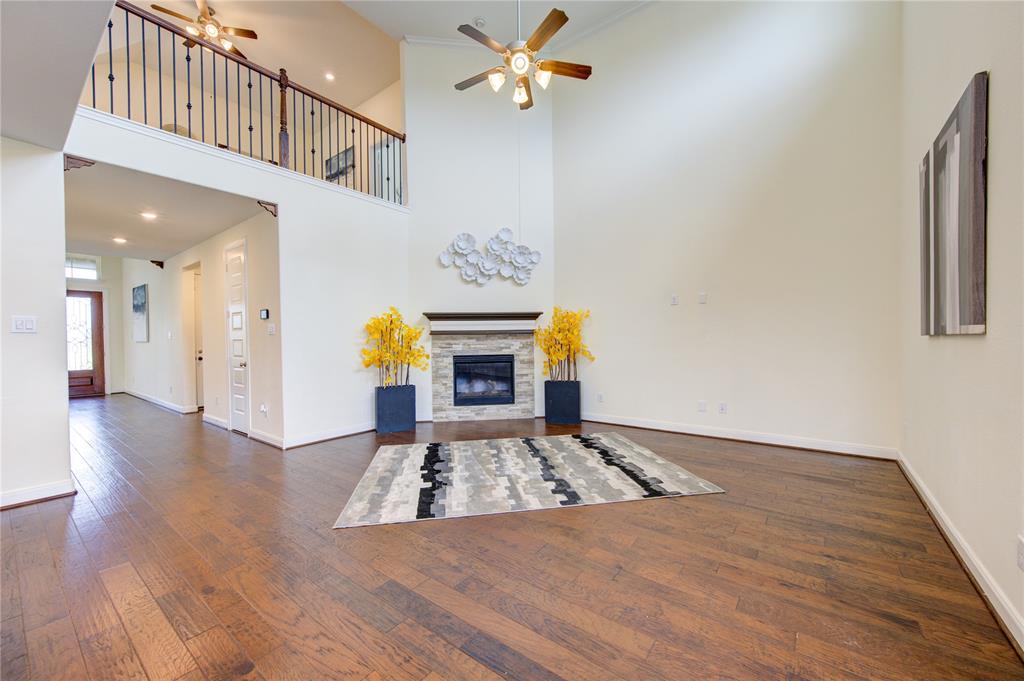 Family room with spectacular high ceilings and fireplace.  These handscraped wood floors are the perfect compliment to this room.