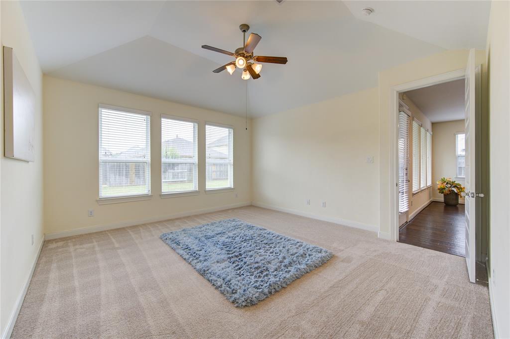 Another view or primary bedroom number one.  An entire wall of windows and wonderful view of the backyard.  These angled ceilings are a perfect compiment to the room.