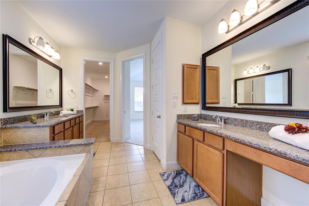 Another view of the primary en suite bathroom looking towards the walk-in closet and primary bedroom. You can see the two separate sinks and vanity.  This is where you will want to begin and end your day!