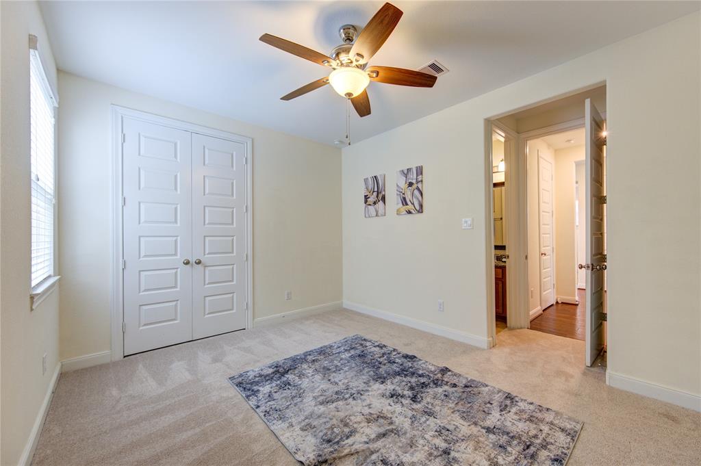 Another view of bedroom number 2.  Ceiling fan and tons of natural light.