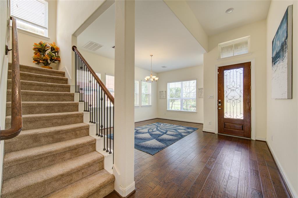 Beautiful entry!  The gorgeous hand scraped wood flooring are spectacular and make the home feel warm and inviting.