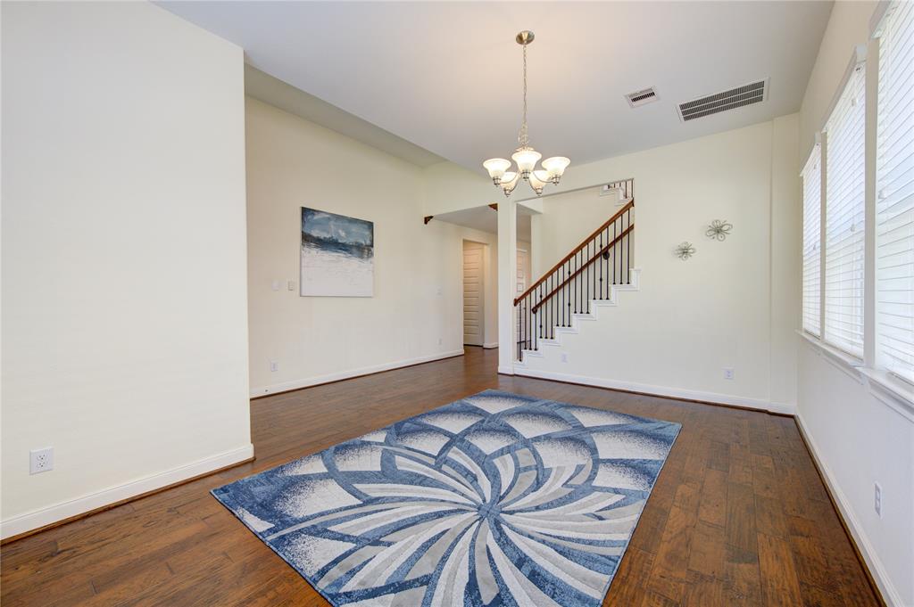 Another view of dining room showing it nice and open.  Beautiful chandelier and excellent natural light.