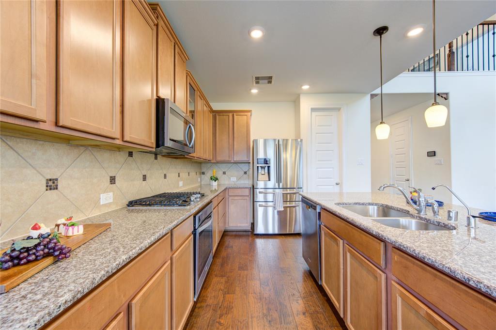 All stainless steel appliances and granite countertops and tile backsplash.  The chef of your family will love this kitchen!  To the left is the stainless steel oven, microwave and gas cooktop.