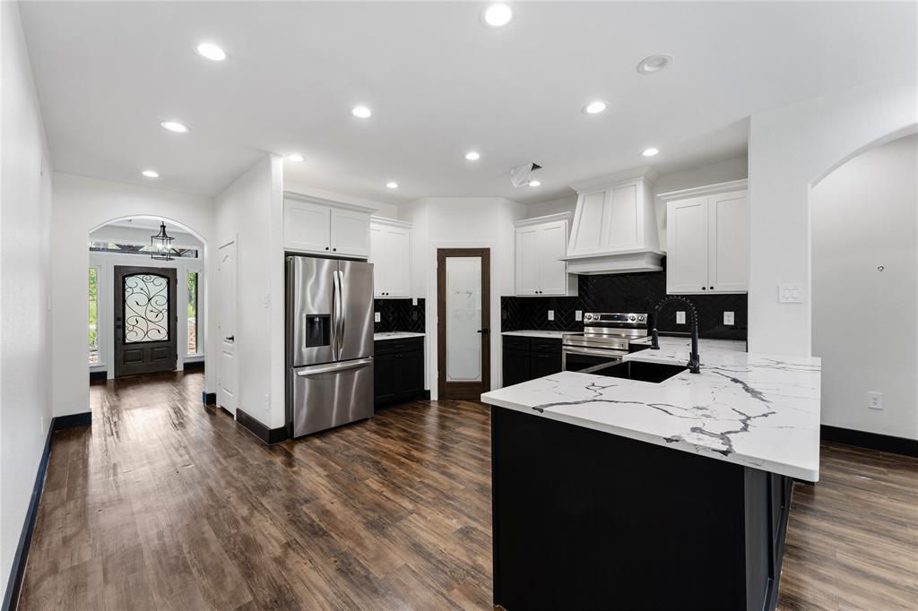 Custom pantry door, black tile backspace and pull up some barstools for extra seating.