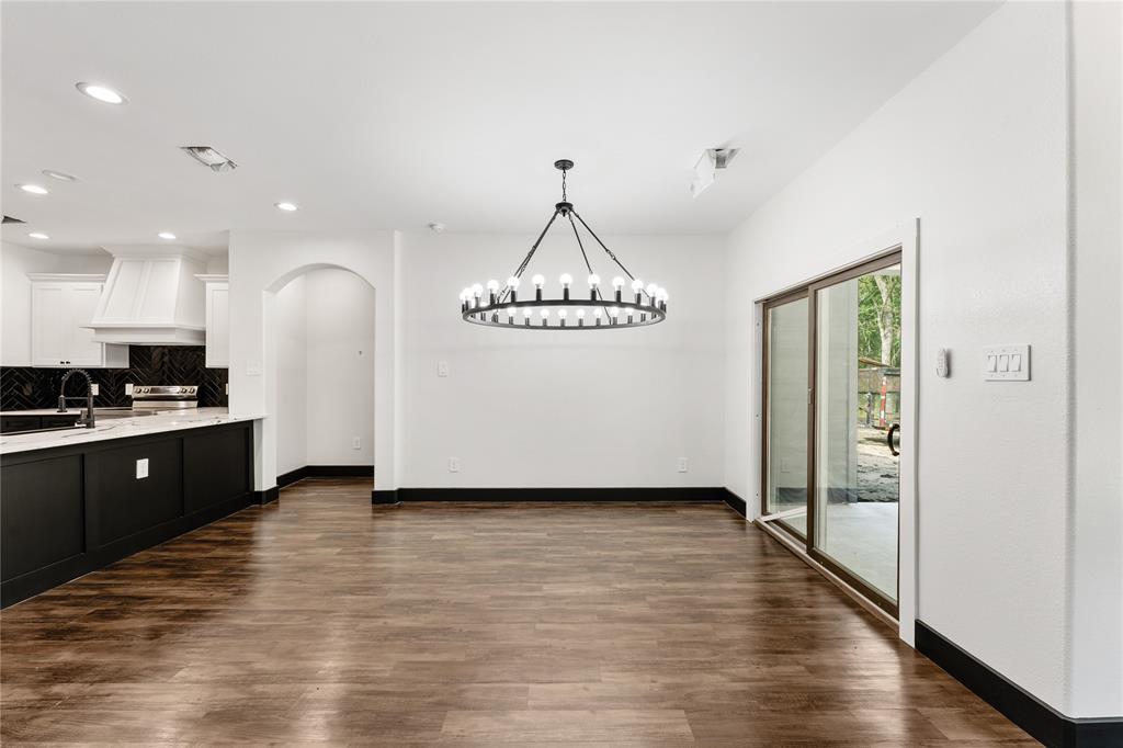 Upgraded light fixture to elevate this space and sliding glass doors open up to outside area.