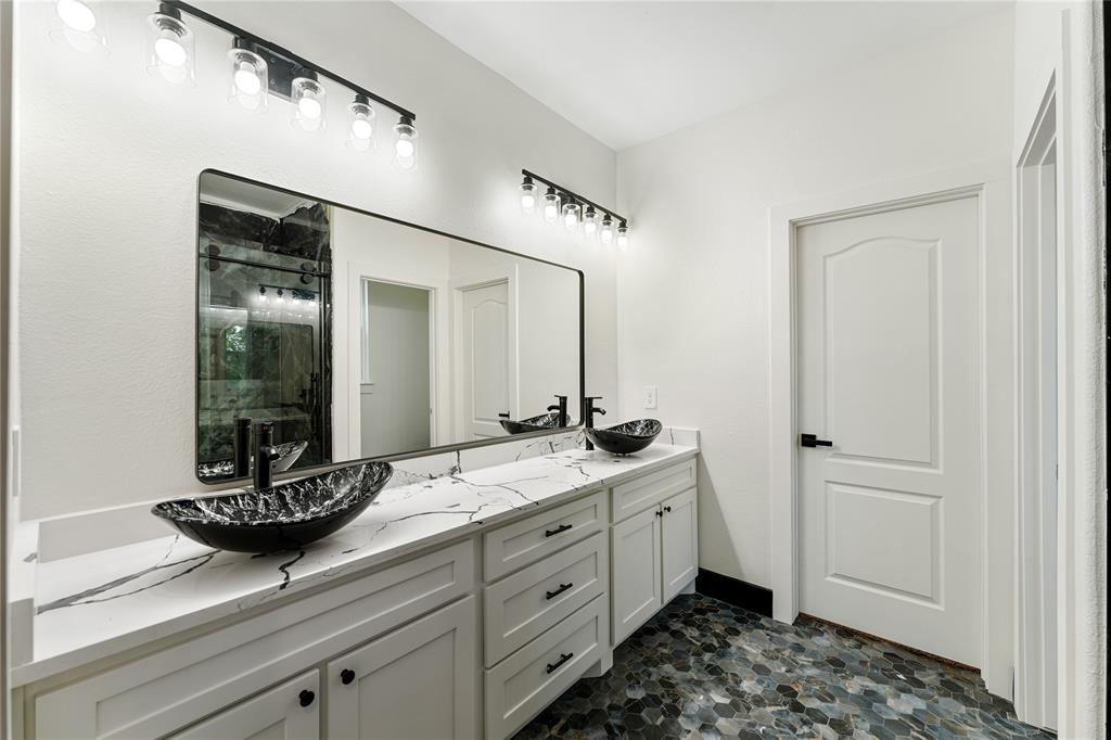 Double vanities, granite countertops, large vessel sinks, lots of storage.