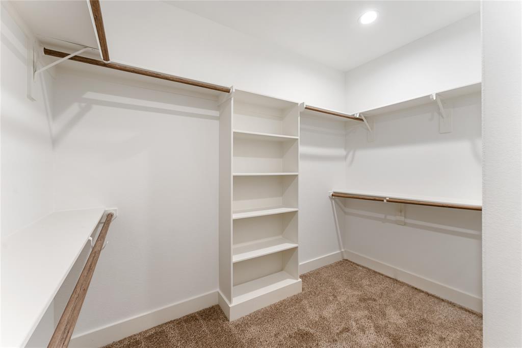 Large walk-in closet with built in shower rack.